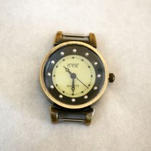 Zifferblatt bronzefarbene und schwarze Uhr mit Federn