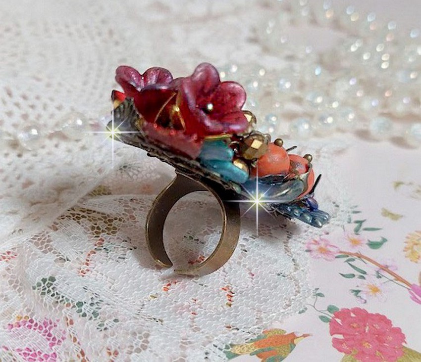 Bague Onia pour une composition florale créée avec des cristaux, fleurs : perles, clochettes, pensées, gouttes Druzy,  pierre de gemme : le Corail, perles cloisonnées et bague ovale en Laiton