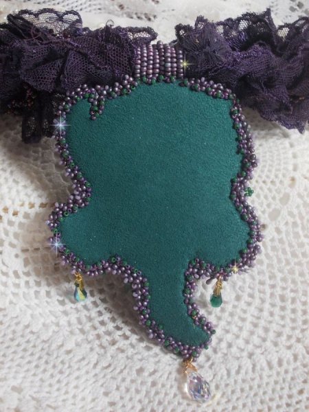 Haute-Couture Blumenpoesie-Anh&auml;nger bestickt mit Porzellanblumen, sehr alter violetter Spitze, Kristallen, Rocailles mit Accessoires aus 925er Silber und vergoldet.